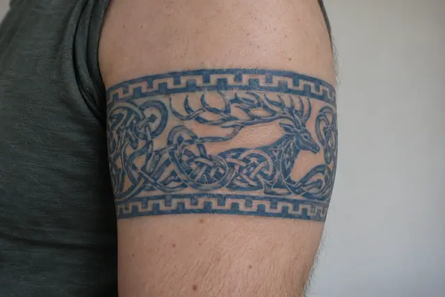 Woad blue Celtic animal tattoo on the arm (armband)