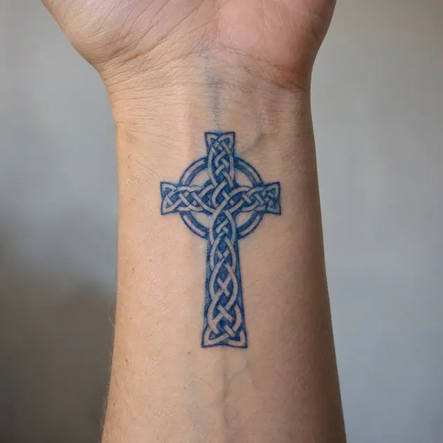 Woad blue Celtic cross tattoo on the wrist