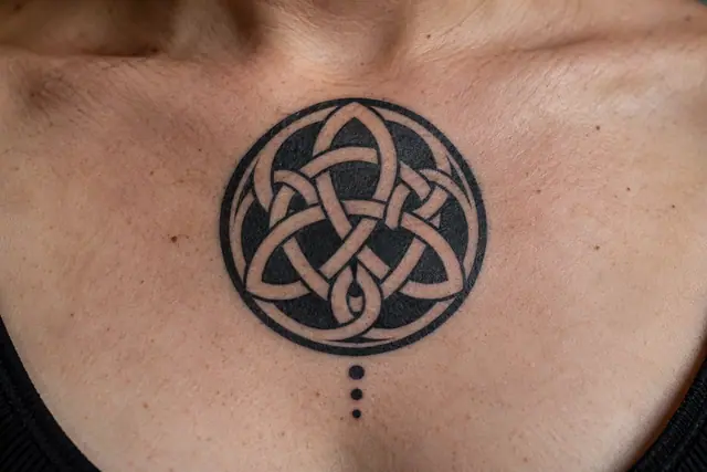 Blackwork Celtic knot tattoo on the chest