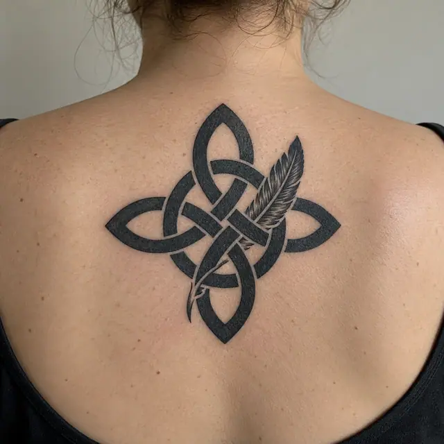 Blackwork Celtic knot tattoo on the upper back
