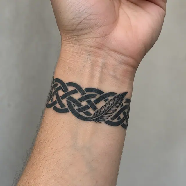 Blackwork Celtic knot tattoo on the wrist