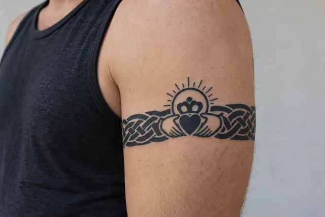Blackwork Claddagh tattoo on the arm (armband)