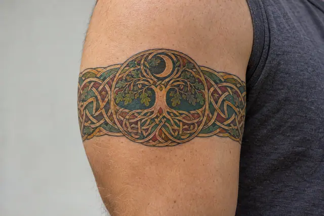 Color illuminated Celtic tree of life tattoo on the arm (armband)