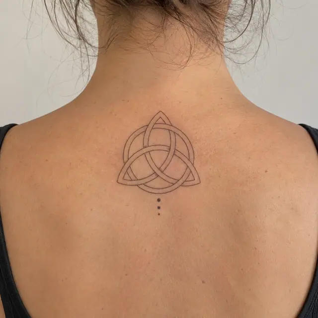 Fine-line trinity knot tattoo on the upper back
